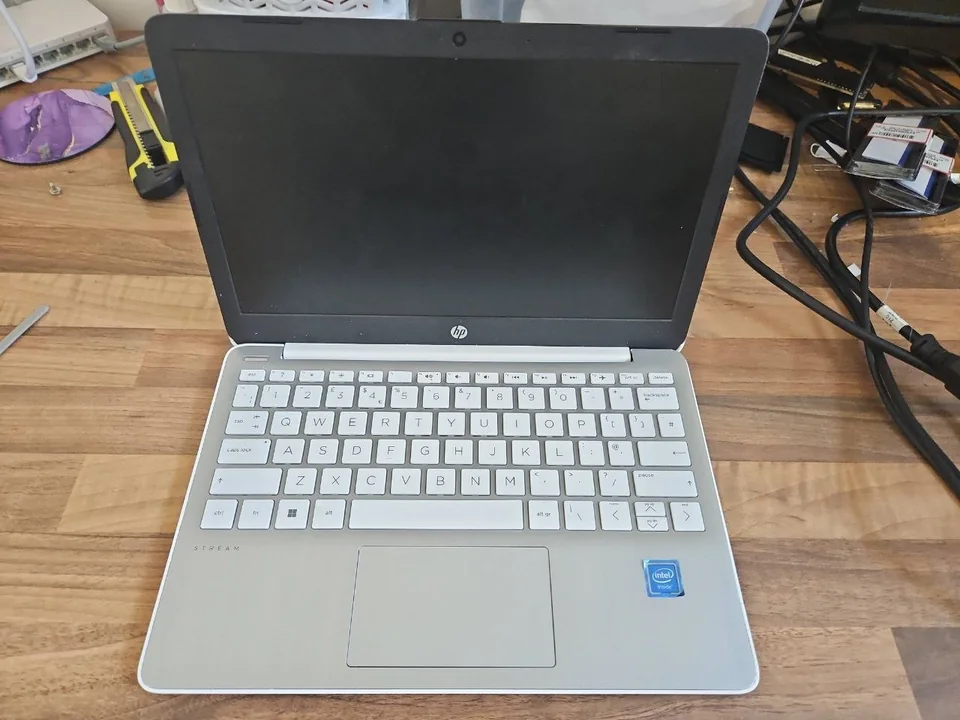 Laptop battery replacement HP Stream laptop on a workshop bench before battery diagnosis in Birmingham