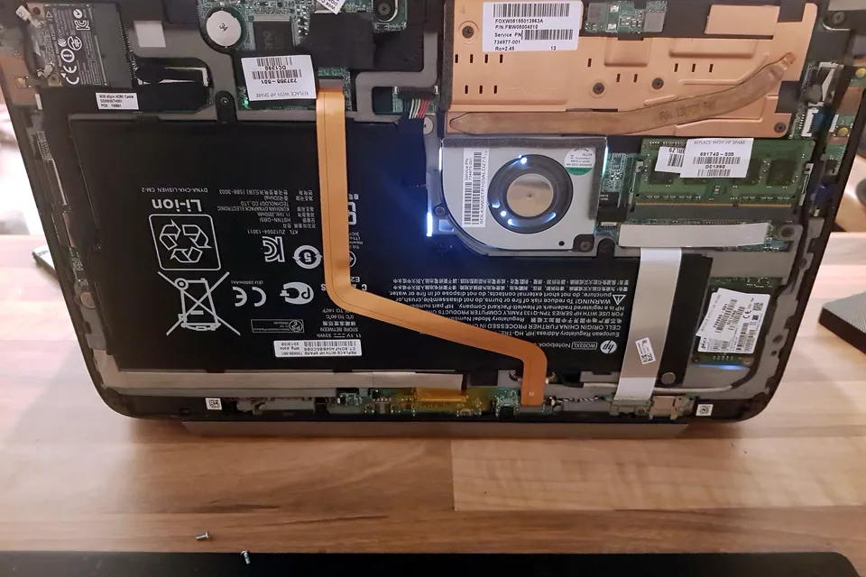 Laptop motherboard, battery and cooling system exposed for diagnosis Laptop motherboard, battery and cooling system exposed for diagnosis